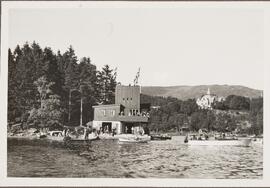 Photograph of Different Boats around a Boathouse